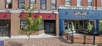 Belleville apartment for rent - A tree in front of a building with a sign that says UpFront.