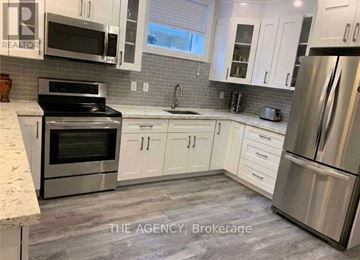 Toronto (Clanton Park) other for rent - A kitchen with white cabinets and stainless steel appliances.