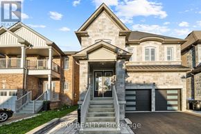 Bradford West Gwillimbury (Bradford) house for rent - A large house with a stone facade and a garage is for sale.