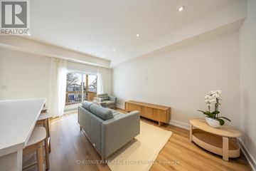 Toronto (Caledonia-Fairbank) fourplex for rent - A living room with a grey couch and a wooden coffee table.