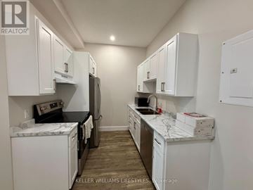 St. Thomas multi-family for rent - A kitchen with white cabinets and appliances.