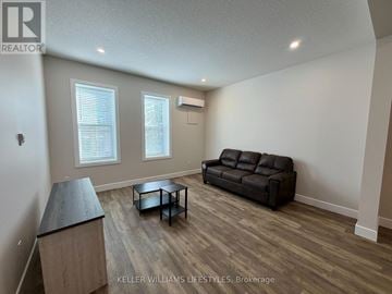 St. Thomas multi-family for rent - A living room with a black leather couch and a wooden coffee table.