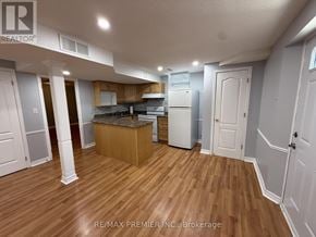 Vaughan (Elder Mills) house for rent - A kitchen area with wooden floors and white appliances.