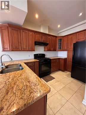 Hamilton apartment for rent - A living room with a grey couch and a wooden coffee table.
