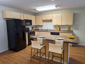 East Grand Forks apartment for rent - a kitchen with a large island and black appliances
