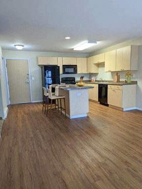 East Grand Forks apartment for rent - a kitchen with an island and a table with chairs