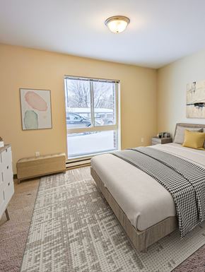 East Grand Forks apartment for rent - a bedroom with a bed and a large window