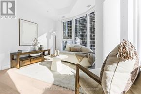 Ottawa condo for rent - A living room with a white couch and a wooden coffee table.