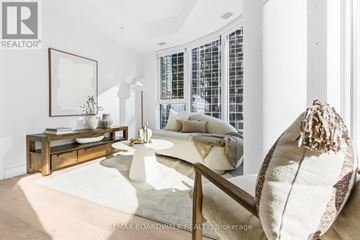 Ottawa condo for rent - A living room with a white couch and a wooden coffee table.