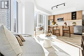 Ottawa condo for rent - A modern living room with a kitchen area in the background.
