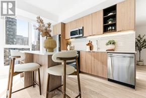 Ottawa condo for rent - A kitchen with a white counter top and wooden bar stools.