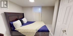 Hamilton (Centremount) house for rent - A bedroom with a bed, pillows, and a window with curtains.