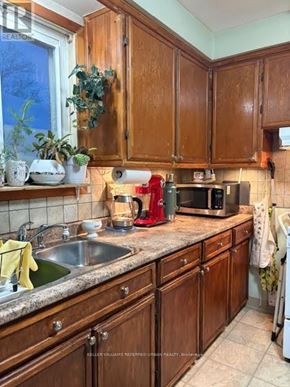 Toronto (West Hill) house for rent - A kitchen with wooden cabinets and a granite countertop.