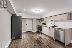 For rent in Toronto (Kingsway South) - A kitchen with a black fridge and stainless steel dishwasher.