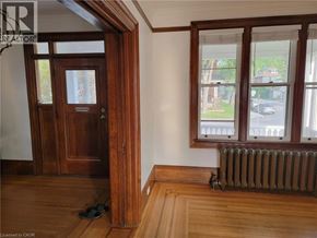 Hamilton house for rent - A room with a brown door and a window with a view of a street.