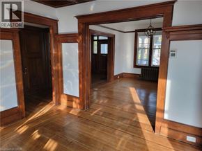 Hamilton house for rent - A room with wooden floors and white walls.