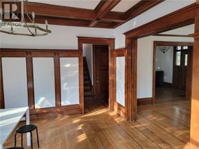 Hamilton house for rent - A room with wooden floors and a staircase.