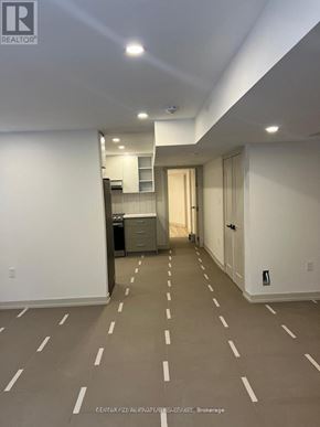 Pickering house for rent - A spacious room with wooden flooring and white walls.