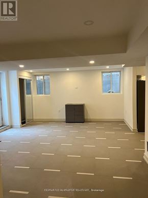 Pickering house for rent - A spacious room with a staircase and wooden flooring.