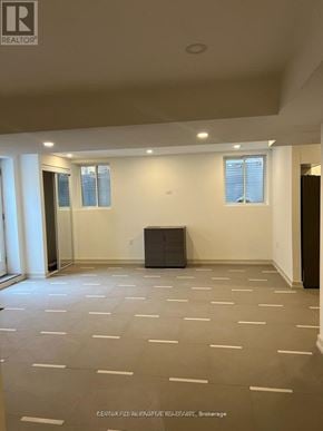 Pickering house for rent - A spacious room with wooden floors and white walls.