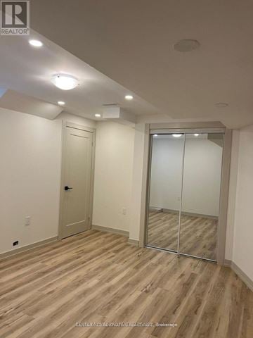 Pickering house for rent - A spacious kitchen with white cabinets and a black countertop.