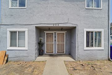 Richmond apartment for rent - A grey house with the number 203 on the front.