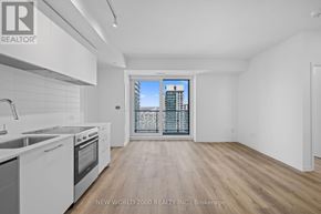 Toronto (Mount Pleasant West) condo for rent - A spacious kitchen with white appliances and wooden flooring.