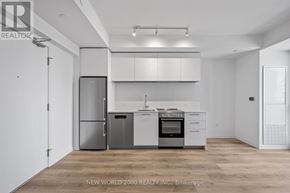Toronto (Mount Pleasant West) condo for rent - A kitchen with white cabinets and stainless steel appliances.