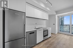 Toronto (Mount Pleasant West) condo for rent - A modern kitchen with a stainless steel refrigerator and white cabinets.