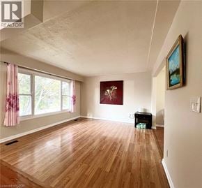 Waterloo house for rent - A room with wooden floors and a painting on the wall.