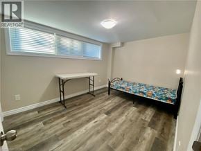 Waterloo house for rent - A bedroom with a bed, table, and window.