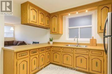 Toronto (High Park North) triplex for rent - A kitchen with wooden cabinets and a sink.