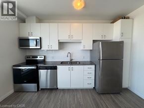Kitchener condo for rent - A waiting area with a couch and a door leading outside.