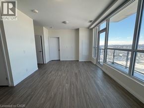 Kitchener condo for rent - Two blue chairs with orange pillows in front of a painting.