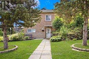 Hamilton (Ainslie Wood) multi-family for rent - A house with a lawn and trees in front of it.