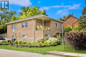 Hamilton (Ainslie Wood) multi-family for rent - A house with a well-maintained lawn and a clear blue sky above.
