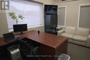 For rent in Toronto (Weston) - A REALTOR sign is on the corner of a desk in an office.