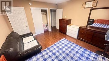 Toronto (Newtonbrook East) house for rent - A living room with a black leather chair and a blue and white checkered rug.