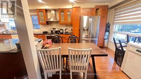 Toronto (Newtonbrook East) house for rent - A kitchen with wooden cabinets and a stainless steel refrigerator.