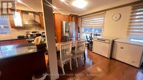 Toronto (Newtonbrook East) house for rent - A kitchen with wooden floors and a white refrigerator.