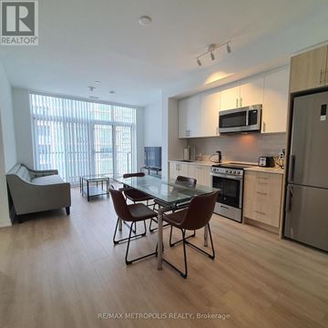 Toronto (Islington-City Centre West) condo for rent - A modern kitchen with a dining table and chairs.