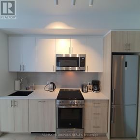 Toronto (Islington-City Centre West) condo for rent - A kitchen with white cabinets and stainless steel appliances.