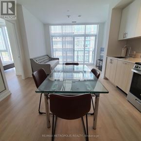 Toronto (Islington-City Centre West) condo for rent - A dining room with a glass table and chairs.