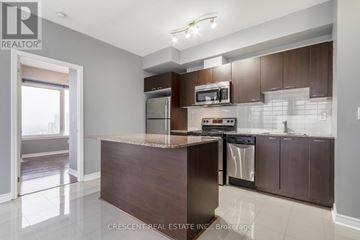 Mississauga (City Centre) condo for rent - A kitchen with a brown counter and stainless steel appliances.