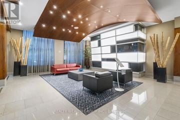 Toronto (Willowdale East) condo for rent - A modern living room with a red couch and a wooden ceiling.