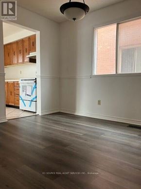 Ajax (Central) house for rent - A room with wooden floors and a window with white curtains.