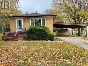 Newmarket (Huron Heights-Leslie Valley) house for rent - A house with a red door and a green bush in front.