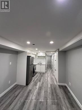 Toronto (Caledonia-Fairbank) multi-family for rent - A long hallway with a kitchen area at the end.