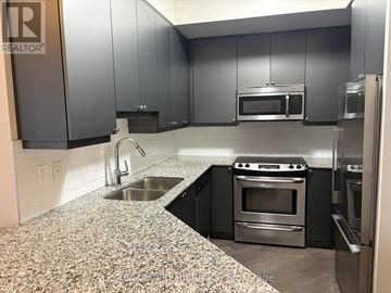 Toronto (Edenbridge-Humber Valley) condo for rent - A kitchen with granite countertops and stainless steel appliances.