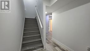 London North (North C) house for rent - A staircase in a house with a logo on the wall.